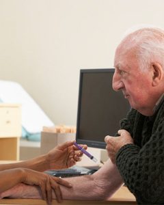 nurse injecting senior male patient