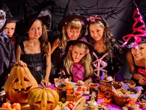 46184257 - children on halloween party  making carved pumpkin