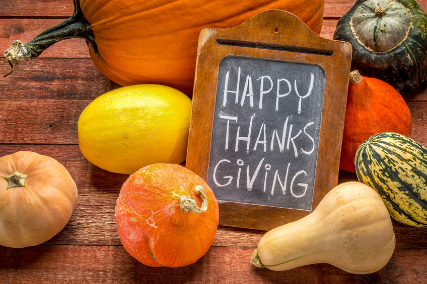 46177351 - happy thanksgiving - white chalk handwriting on a small blackboard surrounded by pumpkin and winter squash