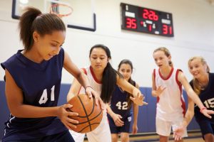 33478120 - female high school basketball team playing game